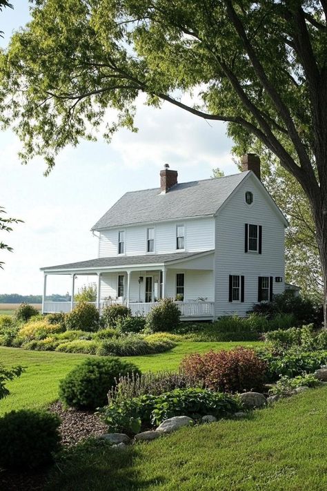 Countryside farmhouse cottage in white siding grey roof front porch landscape with geometric shrubs an trees. The whimsical allure of countryside houses makes these charming abodes more than just a roof and four walls amidst the rolling hills and chattering wildlife. Vintage Farmhouse Outside, 1940s Farmhouse Exterior, Sage Farmhouse Exterior, Small Country House Exterior, Country Farmhouse Outside, 1900s Farmhouse Exterior, Gothic Farmhouse Exterior, Vintage Farmhouse Exterior, Farmhouse Driveway