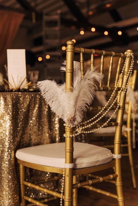 art deco wedding ideas feathers and pearls chair decoration Art Deco Wedding Ideas, Great Gatsby Prom Theme, Chair Decoration Ideas, Masquerade Party Themes, Old Hollywood Prom, Great Gatsby Prom, Gatsby Birthday Party, Gatsby Gala, 1920s Wedding Theme