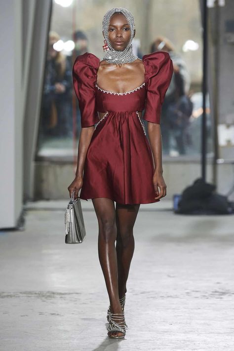 This dress from Area's Fall 2020 collection contains a shortened version of the original gigot sleeve. Traditional gigot sleeves extend to the wrist, whereas the sleeves here end at the elbow. However, they can still be considered gigot sleeves because of their general shape and how the majority of their fullness lies at the shoulders before they gradually decrease in diameter. Mutton Sleeve, Gigot Sleeve, Cutout Mini Dress, Romantic Period, Leg Of Mutton Sleeve, Fashion Week Runway, Celebrity Street Style, White Shirt Dress, Daily Dress