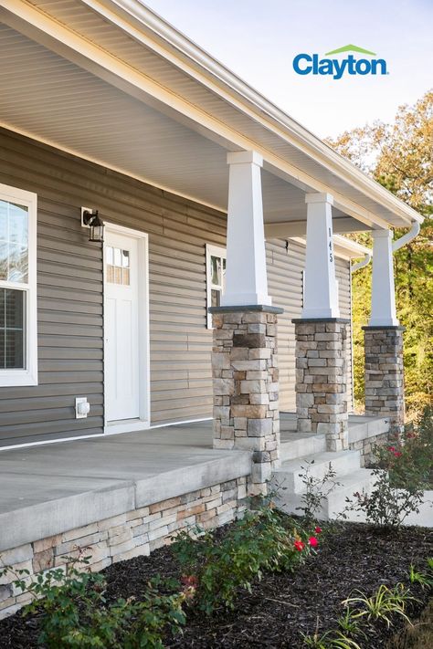 Mobile home exterior with covered front porch and stack stone skirting Double Wide With Brick Skirting, Doublewide Mobile Home Remodel Exterior, Mobile Home With Brick Skirting, Skirting Mobile Home Ideas, Double Wide Brick Skirting, Double Wide Front Porch Ideas Exterior, Double Wide Foundation Ideas, Mobile Home On Foundation, Under Pinning For Mobile Homes