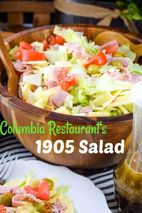 Columbia's 1905 Salad - crisp iceberg lettuce with julienne baked ham, Swiss cheese, tomato, olives, grated Romano cheese and tossed with a garlic vinaigrette dressing. You can enjoy this original made famous by the Columbia Restaurant right at home! #1905salad #columbiasalad #salad Marry Me Salad, Garlic Vinaigrette Dressing, 1905 Salad Recipe, 1905 Salad, Garlic Vinaigrette, Columbia Restaurant, Cheese Tomato, Savory Salads, Romano Cheese