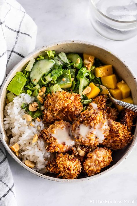 Crispy, incredible, and over-the-top delicious coconut shrimp bowls make the best dinner. If you're short on time, I have an easy kitchen hack to help you get these bowls on the table in just 20 minutes! #theendlessmeal #dinner #coconutshrimp #shrimp #coconut #shrimpbowls #dinner Coconut Shrimp Bowl, What To Serve With Coconut Shrimp, Coconut Shrimp Meal, Asian Shrimp Bowl, Mediterranean Shrimp Bowl, Cajun Shrimp Bowl, 400 Calorie Dinners, Coconut Shrimp Dinner, Coconut Shrimp Salad