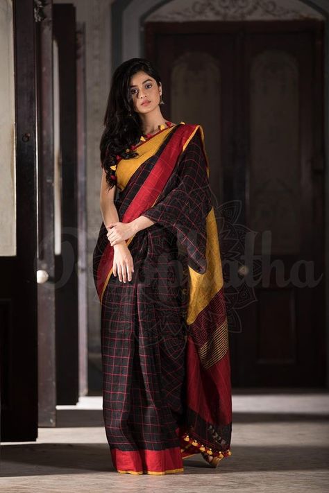 Handwoven Linen Saree Checkered Black linen by linen saree with Ganga Jamuna border in a evergreen combination of red and yellow is sure to draw everyones attention. The pallu is neatly finished with pom poms in contrast colour and comes with contrast blouse. You can also match a kalamkari or an Checks Saree, Sabyasachi Lehenga, Sari Design, Saree Style, Saree Poses, Simple Sarees, Red Lehenga, Saree Photoshoot, Linen Saree