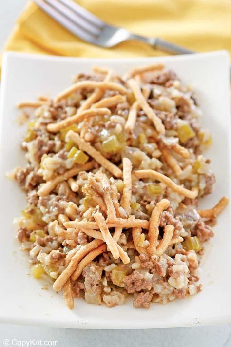 American Chop Suey is a classic comfort food dish with simple ingredients. It’s a hearty meal of ground beef, mushrooms, and rice in a creamy sauce topped with crunchy chow mein noodles. Get the easy recipe and find out how to make the best American chop suey with rice for dinner. This hamburger casserole is also known as American Goulash. #americanchopsuey #chopsuey #comfortfoodrecipes #groundbeefrecipes #casserolerecipeseasy #ricerecipesfordinner Hamburger And Rice Recipes, Pork Chop Suey, Mushrooms And Rice, Ground Beef Mushrooms, Rice For Dinner, American Chop Suey, Hotdish Recipes, American Goulash, Hamburger Casseroles Recipes