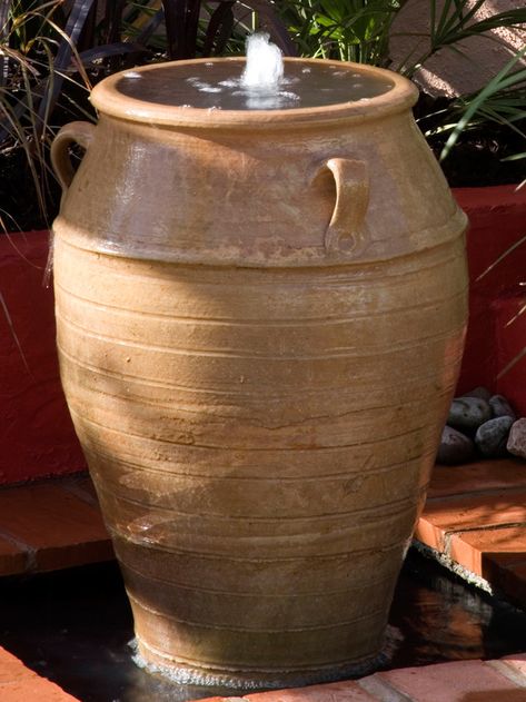 Bubble Fountain A tall terra-cotta pot is lined and used as a bubble fountain, perfect for a terrace feature. Water circulates from a reservoir concealed below Terracotta Water Fountain, Terracotta Pot Water Feature, Urn Water Feature, Terracotta Fountain, Urn Fountain, Bubble Fountain, Gorgeous Entryway, Pot Fountain, Entryway Garden