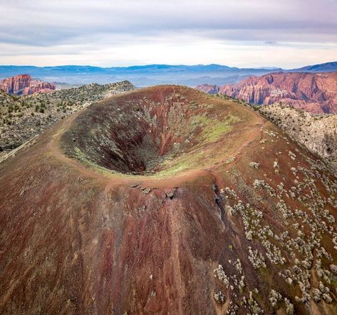 Drone shot of an extinct cinder cone volcano, the red cliffs in Snow Canyon State Park are visible in the background. A cinder cone is a… Page Utah, Cinder Cone Volcano, Extinct Volcano, Shield Volcano, Snow Canyon State Park, Wonderful Nature, Life Help, Spiritual Journey, Volcano