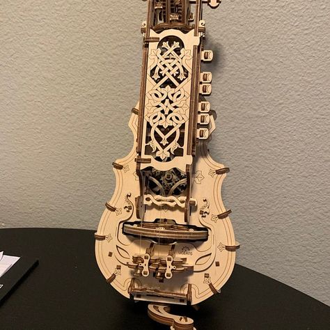 Hurdy-Gurdy is, above all, a real musical instrument that can be leaned and played. 6 keys are spring-loaded with rubber bands and little cranks in the keybox to ensure softer and more convenient play. Also the Ugears Hurdy-Gurdy has a special mechanism to adjust the height of both strings (melody and bourdon string) on the bridge and the beautiful planetary gears mechanism inside the body. Hurdy Gurdy, Homemade Instruments, Wooden Educational Toys, Mechanical Model, Toy Musical Instruments, Diy Musical Instruments, 3d Puzzles, 3d Laser, Wooden Puzzles