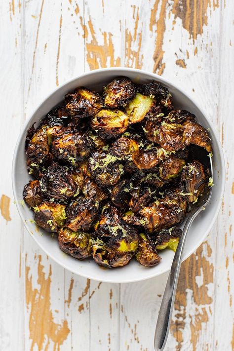 These crispy roasted restaurant-style brussels sprouts have quickly become our favorite way to prepare brussels sprouts. These brussels are halved and roasted cut side down on a hot baking sheet until they're golden brown and ultra tender. While you can certainly eat them as is, they're finished with a drizzle of balsamic glaze, honey, and freshly zested lemon. #brusselsprouts #roastedveggies Brussels Sprout Roasted, Fresh Brussel Sprout Recipes, Balsamic Glazed Brussel Sprouts, Honey Roasted Brussel Sprouts, Balsamic Glaze Brussel Sprouts, Baked Brussel Sprouts, Balsamic Brussel Sprouts, Crispy Brussels Sprouts, Crispy Brussel Sprouts