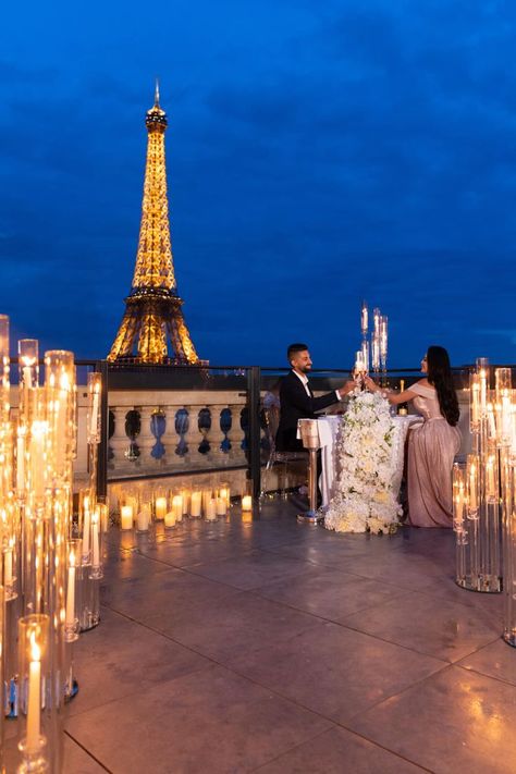 A couple toasting champagne glasses in front of the Eiffel Tower Paris Proposal Aesthetic, Proposal At Night, Proposal Dinner, Proposal Aesthetic, Luxury Proposal, Paris Proposal, Paris Engagement Photos, Dream Proposal, Proposal Pictures