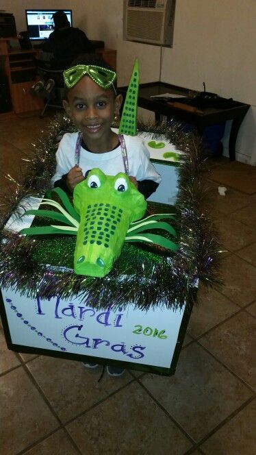 Mardi Gras alligator kid float. Made with foam board, paper mache,  and paint. Alligator Mardi Gras Float, Diy Mardi Gras Float For Kids, Mardi Gras Kids Float, Kids Mardi Gras Float Wagons, Wagon Mardi Gras Float For Kids, Mardi Gras Wagon Float Ideas For Kids, Prek Projects, Wagon Floats, Mardi Gras Parade Float