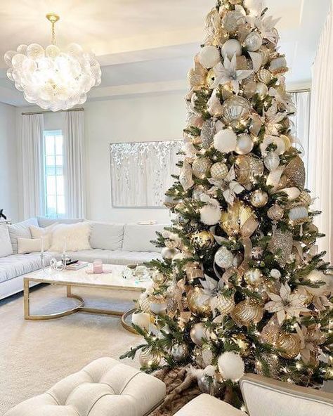 75+ Elegant White And Gold Christmas Tree Ideas [2023] For A Stunning Holiday (With Videos!) Ivory Gold Christmas Tree, White Gold Christmas Tree Decorations, Christmas Tree With White Poinsettia, Christmas Tree Decorations White And Gold, White Poinsettia Christmas Tree, White Gold Christmas Tree Ideas, White And Gold Christmas Tree Ideas, White And Gold Christmas Tree Decor, Gold And White Christmas Tree Ideas