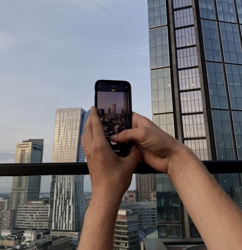 an aesthetic picture of person taking picture of warsaw by their phone. picture in picture aesthetic. People Taking Pictures With Phone, Phone Taking Picture Aesthetic, Picture Of Someone Taking A Picture, Picture Of A Person, Picture In Picture, Warsaw City, Aesthetic Picture, 2025 Vision, An Aesthetic