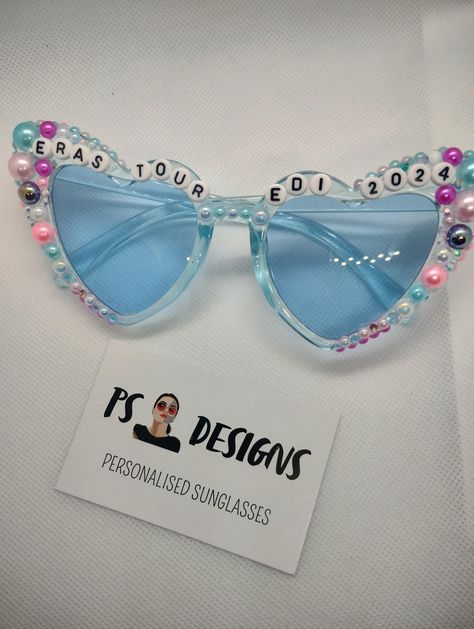 Eras Tour Edi 2024 see-through pale blue heart shaped sunglasses with colourful pearls. Eras Tour Heart Glasses, Eras Tour Sunglasses, Color Celeste, Heart Glasses, Heart Shaped Sunglasses, Friendship Bracelets Designs, Blue Heart, Celebrity Outfits, Eyewear Sunglasses