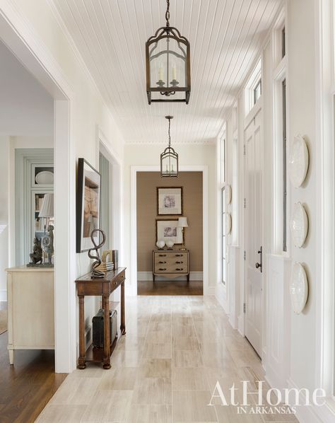 Simply. Stunning. | At Home in Arkansas Beadboard Ceiling Hallway, Travertine Foyer, Wainscotting Ideas, Accent Wall Entryway, High Ceiling Lighting, Nursery Accent Wall, Alternative Flooring, Accent Wall Colors, Bathroom Accent Wall