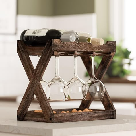 Real Wood: Paulownia wood is used in applications which is lightweight yet proportionately strong, sustainable real wood. Multi-Functional: This table top farmhouse décor bottle storage solution is perfect for storing liquor bottles and hanging fluted glasses at the same time. You can use it on your countertop to store your favorite wine bottles and stemware glasses. Dimensions: H 13 1/4" x W 15 1/4"x D 9" Hanging Bar Storage: With this vertical free-standing wine bottle holder you can create breathing room in your kitchen, hutch, buffet, credenza or bar cart. To create a simplistic yet stylish bar organization hang this above your bar cart to give your living space a makeover. Farmhouse Décor: The rustic wood will add industrial flair and rustic style to your living space, you can use thi Wine Holder Ideas, Wine Cork Storage, Bar Organization, Cork Storage, Hutch Buffet, Tabletop Wine Rack, Wine Cart, Wood Wine Rack, Table Top Wine Rack