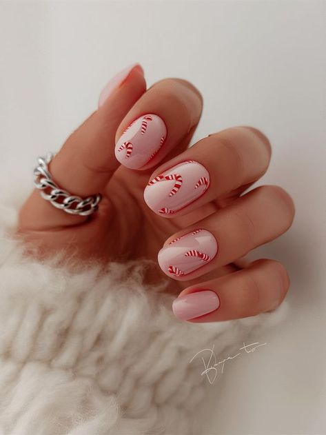 This candy cane-inspired nail art brings the sweetness of the season right to your fingertips. Featuring delicate red and white candy canes on a pale pink base, this fun and festive look is perfect for Christmas, adding a touch of holiday cheer to your winter wardrobe. Christmas Candy Nails, Cowboy Nails, Christmas Nail Ideas, Candy Cane Nails, Red Christmas Nails, Special Nails, Fancy Nails Designs, Edgy Nails, Nail Candy