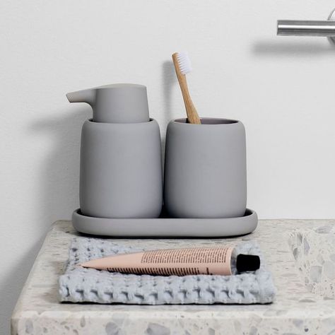 We rounded up some of the sleekest yet functional decor items we could find. From cement soap dispensers to marble trash cans, scroll down for 10 bathroom accessories any minimalist would love. #hunkerhome #minimalist #bathroom #bathroomaccessory #minimalistbathroom Home Decor Ideas Videos, Toothbrush Organization, Bathroom Tumbler, Teen Furniture, Ideas Videos, Stylish Curtains, Bathroom Plants, Oval Tray, Oil Dispenser