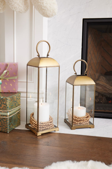 Add a touch of refinement to your home decor with these elegant Antique Brass & Glass Cargo Lanterns. Available in two sizes, our exclusive glass and metal lanterns can spruce up your space alone, or pair the different sizes on your console table or mantel. #WorldMarket Glass Lantern Filler Ideas, Lantern Filler Ideas, Brass Lanterns, Geometric Lantern, Table Lanterns, Lantern Decor, 2025 Spring, Gold Lanterns, Brass Accessories