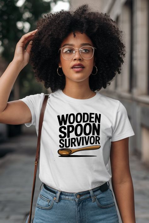 wooden spoon survivor, t-shirt design, wooden spoon clip art, funny t-shirt, nostalgic humor, drop shadow illustration, white t-shirt design, playful design, childhood memories, humorous t-shirt, wooden spoon art, custom t-shirt, kitchen humor, survivor t-shirt, unique t-shirt graphic. Wooden Spoon Survivor, Fun Clip, Drop Shadow, Bold Text, Pop Culture References, Wooden Spoon, Art T Shirt, Band Shirts, Sense Of Humor