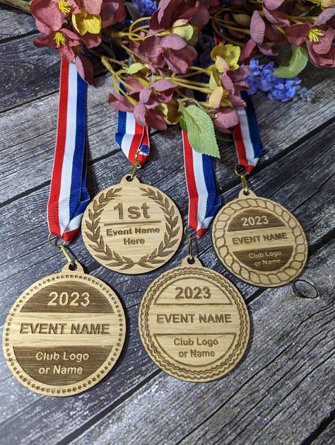 Please note this is the Double sided option, in our shop we also have sinfle sided versions. Make your next sports event or competition extra special with our personalized wooden medals! These unique medals are perfect for commemorating the achievements of athletes and participants of all ages and abilities. Crafted from high-quality wood and expertly engraved with your personalized details, these medals come in four unique designs to choose from. Each medal features a high-quality ribbon. We use state-of-the-art laser technology to engrave your details onto the medal, creating a long-lasting and durable finish that will stand the test of time. These personalised wooden medals make the perfect gift for coaches, teammates, and loved ones. Order your set of personalised wooden medals today a Fiber Laser Engraving Ideas, Medal Design Ideas, Wood Medals, Medal Design, Marathon Medal, Events Business, Sports Medals, School Badges, Sports Event