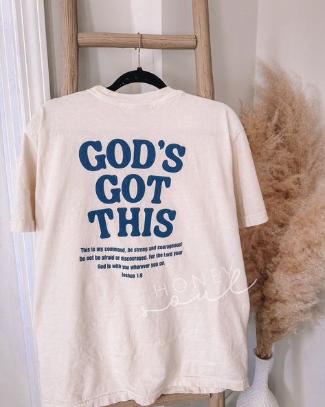 God's Got This Graphic Tshirt Sizing: Unisex (see size guide in photos for measurements) Color: Ivory or White Material: 100% Cotton Brand: Comfort Colors  Design as shown on the front left pocket & back  *cannot be personalized or changed* PROCESSING/TURNAROUND TIME: -Processing/Turn around times may vary. Please check the estimated ship/delivery times.  -Processing/Turn around time DOES NOT include shipping time. christian topsChristianfaith apparelTrendy TopsIn stylewalk by faithEncouragement Christian Gift Shop, Christian Clothes, Christian Clothing Brand, Christian Graphic Tees, Christian Tshirt Design, Jesus Clothes, Christian Shirts Designs, Christian Tshirt, Christian Fashion