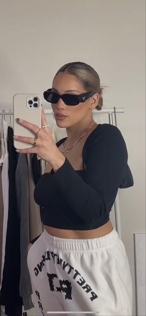 Girl taking a mirror selfie with a pair of Prada symbol sunglasses. wearing a black top and white joggers. Dark Sunglasses Aesthetic, Prada Glasses Outfit, Sunglasses Aesthetic Girl, Prada Sunglasses Outfit, Prada Sunglasses Aesthetic, Sunglasses Aesthetic Outfit, Black Sunglasses Outfit, Black Sunglasses Aesthetic, Prada Black Sunglasses