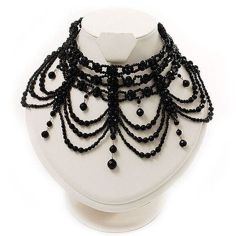 Victorian Black Beaded Choker Adult Stand out from the crowd with this distinctive Victorian Black Beaded Choker Adult. It features a choker bib design, adorned with a cascade of graduated dangles (11cm the longest front drop), made of shiny plastic beads in hues of jet black. The necklace measures about 28cm and fastens with an adjustable silver tone lobster-claw clasp (8cm extender chain) so you control where it falls on your neck to complement any neckline. Victorian Black Beaded Choker Adult product code: N00583 category: Bib Necklaces, Chokers, Necklaces style: victorian occasion: club night out, cocktail party metal finish: rhodium plated material: plastic type: bead jewellery, multi-strand wear on: neck fastening: lobster claw clasp necklace size: choker extension: 8.0cm (3.15") fro Moulin Rouge Dress, Beaded Netting, Rouge Dress, Blue Goth, Pearl Body Chain, Whitby Goth Weekend, Jewels Diy, Gothic Chokers, Signature Necklace