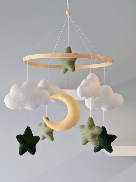 Green Stars and Moon Personalized Baby Mobile  Featuring soft white clouds, charming stars in sage and dark green, and a pale yellow crescent moon, this mobile is perfect for lulling your little one to sleep. It's perfect for nursery decor, baby showers, and as a thoughtful gift for new parents One of the clouds can be personalized. If you would like to add the baby's name on it, please indicate it in the section for personalization. ✳️ Baby mobile Includes 1 moon 2 Dark Green stars 3 Sage stars Gender Neutral Themed Nursery, Neutral And Green Nursery, Dark Green Baby Nursery, Dark Green Nursery Boy, Nursery Inspo Gender Neutral, Gender Neutral Nursery Green, Nursery Ideas Green, Green Nursery Neutral, Baby Room Ideas Neutral