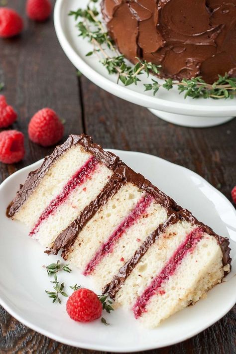 This Chocolate Raspberry Cake has six glorious layers of vanilla cake with raspberry sauce and a rich dark chocolate frosting. | livforcake.com Vanilla Cake With Raspberry, Raspberry Cakes, Raspberry Cake Filling, Raspberry Cake Recipes, Dark Chocolate Frosting, Cake Filling Recipes, A Slice Of Cake, Chocolate Raspberry Cake, Cake Filling