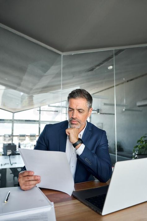 Busy middle aged business man checking financial documents in office. royalty free stock photography Finance Man, Office Shoot, Business Shooting, Stock Photos People, Accounting Office, Finance Jobs, Office Pictures, Doctor Picture, Corporate Photography