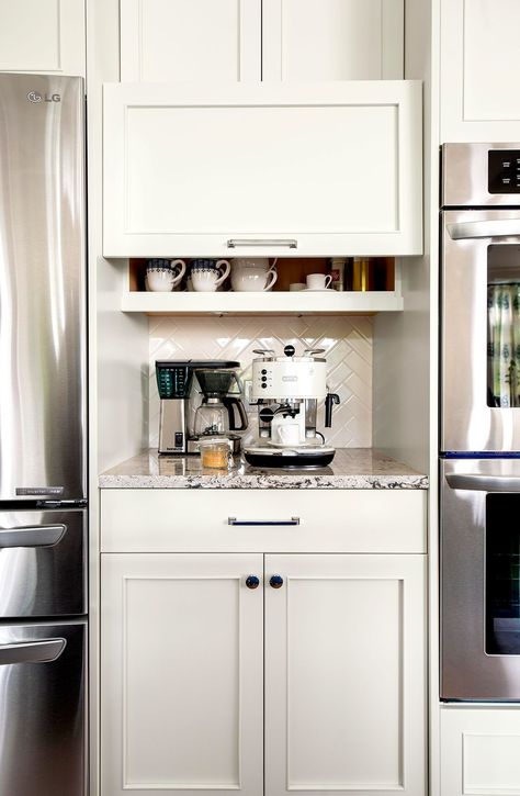 Bridging the gap between fridge and oven, this cabinet puts the coffee station right in the center of cooling and warming stations. A cabinet door slides upward to uncover coffee supplies and cups. #coffeebar #diycoffeebar #athomecoffeestation #coffeebarideas #decor #bhg Coffee Station Ideas, Diy Coffee Station, Coffee Cabinet, Coffee Station Kitchen, Coin Café, Coffee Bar Ideas, Coffee Bar Station, Kabinet Dapur, Home Coffee Stations