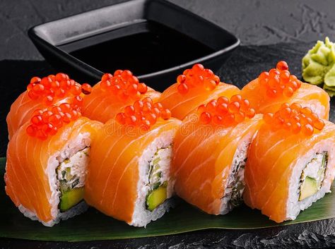 Philadelphia roll sushi with salmon on a dark background royalty free stock photography Salmon Rolls Rice Paper, Sushi With Salmon, Philadelphia Roll Sushi, Smoked Salmon Rice Paper Rolls, Japan Decoration, Sushi Images, Sushi Roll Photography, Philadelphia Roll, Roll Sushi