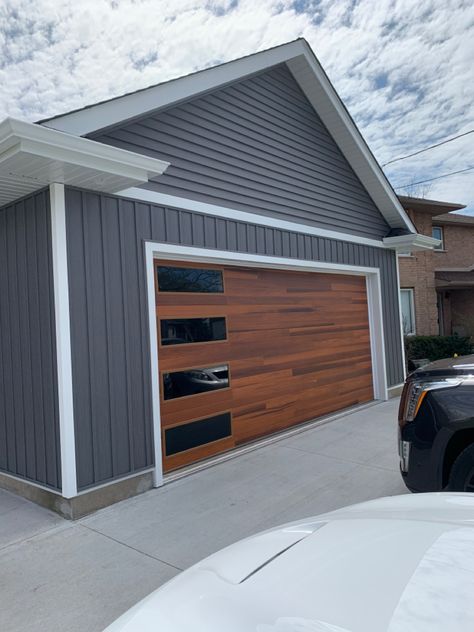 Cedar Plank Garage Door, Grey House Wood Garage Door, Wood Garage Doors Gray House, Garage Siding Ideas, Plank Garage Door, Wood Siding House, Grey Garage Doors, Brown Garage Door, Cedar Garage Door