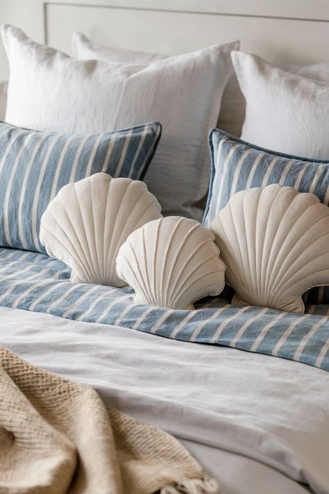 Create a serene sleep sanctuary with the right coastal bedding! Opt for light and airy fabrics like linen or cotton. Choose calming colors like blues, whites, and sandy beiges.  Incorporate nautical patterns or seashell motifs for a touch of coastal charm. [Find the perfect coastal bedding for your bedroom!] Coastal Grand Daughter Bedroom Ideas, Coastal Bedrooms Beige, Beach Home Accessories, Under The Sea Themed Bedroom, Seashell Bedroom Decor, Sea Theme Room Decor Ideas, Coastal Coquette Bedroom, Costal Bedding, Mermaid Bedroom Aesthetic