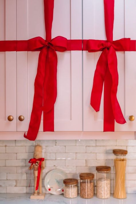 How To Turn Your Kitchen Cabinets Into Christmas Presents | studiodiy.com Christmas Bows On Cabinets, Bow Cabinet Christmas, Ribbon On Cabinet Doors, Christmas Ribbon Decorations, Diy Cabinet Doors, Family Christmas Movies, Christmas Cozy, Christmas Apps, Studio Diy