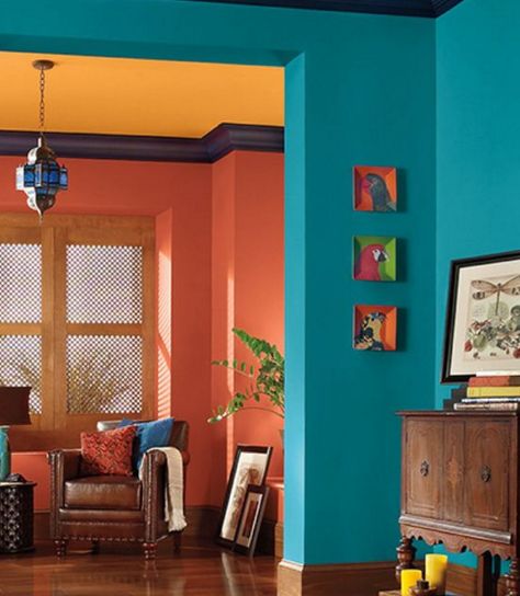 COLOR HARMONY: This is a split-complementary color scheme. The oranges on the back walls and ceiling are not true oranges; one is more red, and the other is more yellow. Room Paint Colors, Room Color Schemes, Blue Living Room, Design Del Prodotto, Love Style, A Living Room, Living Room Paint, Room Paint, Blue Walls