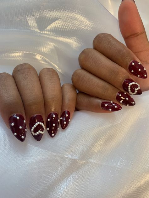 Red Nails With Pearls On Them, Burgundy Nails With Pearls, Dark Vday Nails, Dark Red Nails With Pearls, Nail Art With Pearls Beads, Dark Red Pearl Nails, Red Nails Pearls, Cherry Wine Nails With Design, Red And Pearl Nails