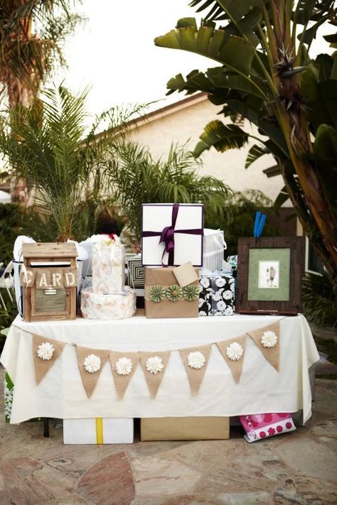 gift table with banner, pom poms hanging above and chalk board that says 'o you shouldn't have' Table With Gifts, Gift Table Decorations Birthday, Display Shower Gift Table Cute Ideas, Gift Table Ideas Graduation, Boho Gift Table Ideas, Gift Table Set Up, Party Gift Table Ideas, Presents Table Wedding, Gifts And Card Table Wedding