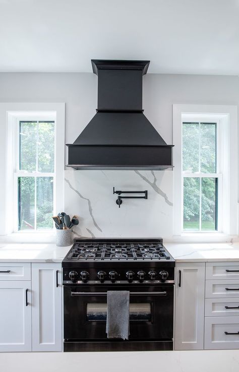 White Kitchen With Black Island And Hood, Black Hood With White Cabinets, Black Exhaust Hood Kitchen, Black Stove Kitchen Ideas, Black Hood Over Range, Black Hood White Cabinets, White Cabinets Black Hood, Black Hood Vents Kitchen, Kitchen With Black Hood