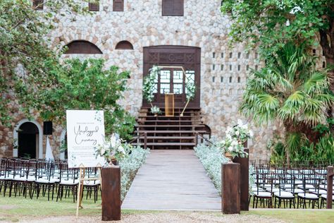 An unplugged ceremony at a tropical destination wedding at Pattoo Castle in Jamaica with wood details, low white-and-green flower arrangements and a gold geometric ceremony arch adorned with florals. Pattoo Castle Jamaica, Ceremony White Flowers, Tropical Destination Wedding, Unplugged Ceremony, Wood Details, Wedding Altars, Wedding Aisle Decorations, Wedding Activities, Tropical Destinations