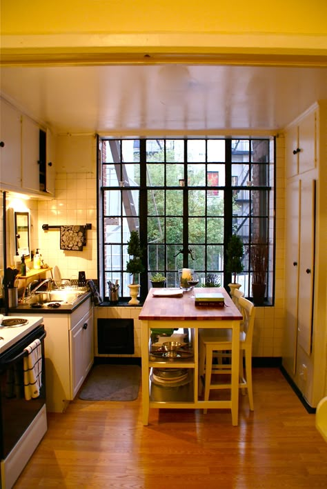 My home in Hell's Kitchen, New York | It rained a lot that summer, and these windows swung open onto a 1922 fire escape. Always reminded me of Paris.. | Stephanie St.Claire Apartment With Fire Escape, 90s Apartment Kitchen, 90s Apartment New York, New York Flat Aesthetic, New York Fire Escape Aesthetic, 1940s Apartment New York, New York Home Decor, Vintage New York Apartment, La Apartment Kitchen