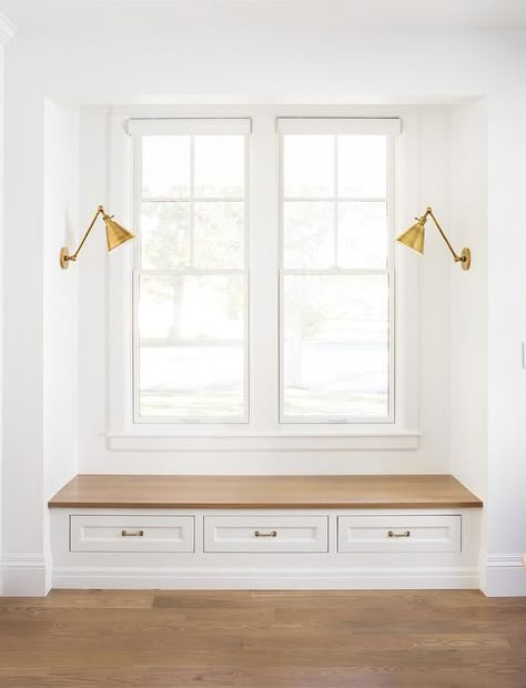 Boston Functional Library Lights illuminate a mudroom window seat nook with a wood top bench and three shaker drawers fitted with brass pulls. Mudroom Window, The Fox Group, Window Seat Nook, Fox Group, Transitional Laundry Room, Window Bench Seat, Window Mudroom, Window Seat Design, Window Nook