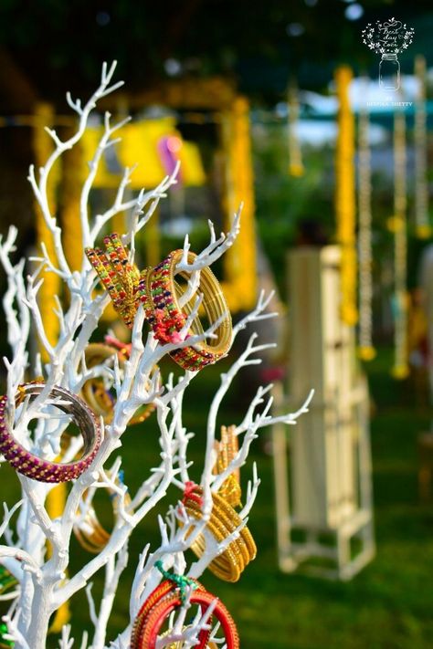 Photo of Bangles on painted branches for mehndi decor Mehndi Decoration Ideas At Home, Pastel Wedding Decorations, Bangle Ceremony, Painted Branches, Mehendi Decor, Indian Wedding Favors, Indian Wedding Planner, Mehndi Night, Wedding Reception Backdrop