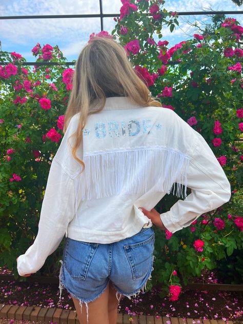 Surprise the bride to be with this fun white sequin & fringe denim bride jacket! This bride jean jacket is the perfect accessory for any bride looking to add some extra sparkle and shine to a bachelorette party, hens party, or engagment party! This fun bride jacket is also a perfect accessory or outfit idea for a disco cowgirl bachelorette , nashville bachelorette , or last rodeo bachelorette party! Cowboy Hat Hair, Bride Jean Jacket, Disco Cowgirl Bachelorette, Last Rodeo, Bride Slippers, Bride Jacket, Cowgirl Bachelorette, Disco Cowgirl, Bride Sweatshirt