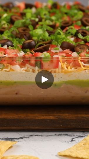 6.4K views · 125 reactions | 7 Layer Dip | 7 Layer Dip! WRITTEN RECIPE: https://bellyfull.net/7-layer-dip/ | By Belly Full | You're celebrating Cinco the Mayo or having people over for game day or it's just a regular taco Tuesday. You can never go wrong with a seven layer dip. Thoroughly combine two cans of refried beans, three ounces of softened cream cheese, and one cup of drained chunky salsa. Then pour it into a nine by 13 glass casserole dish or a trifle dish or you can even split it up into individual cups. Top the bean mixture with two cups of guacamole and make sure to spread it out into a nice even layer. Combine one and a half cups of sour cream with two tablespoons of taco seasoning. And spread that over the guacamole. The next layer is cups of shredded Mexican blend cheese. Fol Seven Layer Dip, Chunky Salsa, Layer Dip, Trifle Dish, 7 Layers, Taco Tuesday, Taco Seasoning, Refried Beans, Trifle