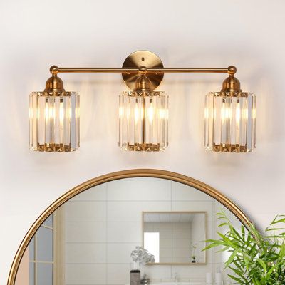 Transform your sophisticated bathroom, living room, or bedroom into a haven of sheer elegance with our opulent 3-light dimmable bathroom vanity light. The captivating electroplated brass finishes seamlessly merge with the crystal-adorned glass shade, introducing a touch of modern luxury and extravagant allure to your intimate spaces. Regardless of your decor style, this vanity light stands out as a unique decorative element, adding a touch of extravagant charm to your home. Elevate your home's a Powder Room Lighting, Gold Light Fixture, Gold Bathroom Decor, Sophisticated Bathroom, Vanity Light Fixtures, Bathroom Vanity Light, Vanity Lights, Gold Bathroom, Modern Glam