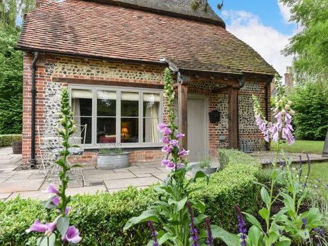 "A true ’Chocolate Box’ cottage with low slung thatched roof over the brick and flint walls of this charming and sympathetically restored cottage in a pretty Hampshire village. With 2 beautiful bedrooms and a comfortable and social open plan living space. Relax on the sumptuous sofa in front of the log stove or rustle up a home cooked meal in the luxuriously hand crafted kitchen. Then pull up chair at the dining table pour a drink relax and catch up after the days activities.\nThe pretty cottage Pembrokeshire Coast, Cosy House, Cathedral City, Rural Retreats, Thatched Cottage, Micro Brewery, Luxury Holidays, English Cottage, Holiday Cottage