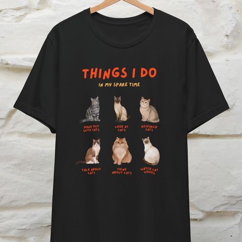 😸 Ever wonder how your cat views your hobbies? Our "Things Humans Do In Their Spare Time" t-shirt is a funny take on it! Available in 100% cotton for men and women, it’s the perfect cozy vibe for cat lovers with a sense of humor. ✨ #thingshumansdo #funnycattshirt #UnisexApparel #viraltshirts #catsofinstagrams #cozycomfortthrow #cathumor #catsoftheday #catloversclub #humor #meme #tshirt #hobbies Cat Tshirts Funny, Cat Watch, Comforters Cozy, Funny Cats, Cat Lovers, T Shirt