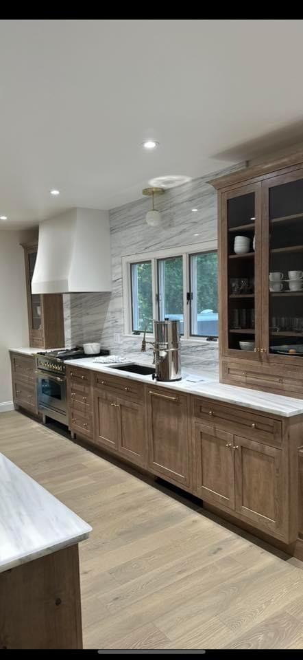 Cabinets - Cappuccino stain on cherry; Marble - calacatta altissimo Medallion Cabinets Cappuccino, Cherry Cappuccino Cabinets, Stained Cherry Kitchen Cabinets, Mocha Cabinets Kitchen, Schuler Cabinets, Medallion Cabinets, Marble Calacatta, Cherry Kitchen, Brown Cabinets