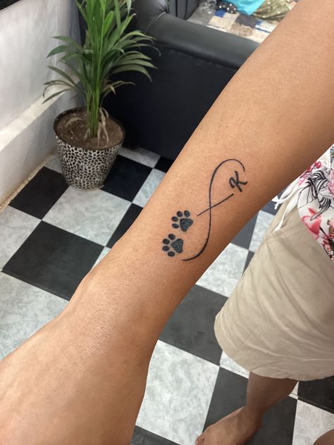 Infinity Tattoo With Dog Paws, Infinity Dog Tattoo, Infinity Tattoo With Paw Prints, Dog Initial Tattoo Ideas, Dog Infinity Tattoo, Dog Tattoo With Name, Paw Wrist Tattoo, Dog Paw Tattoo Design, Paw Tattoo Design